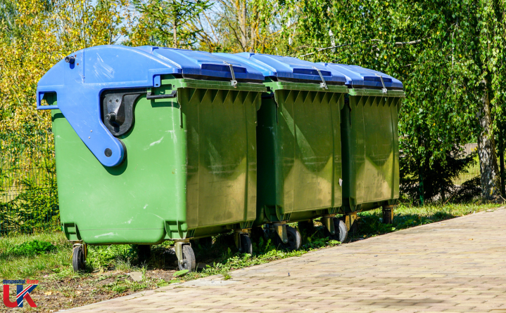 Bins Three wheelie bins in red and blue, featuring the 'UK Commercial Waste logo.