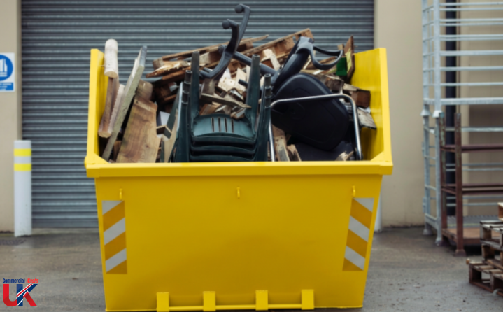 Skips and Rear End Loader A yellow skip filled with mixed construction debris and broken materials.